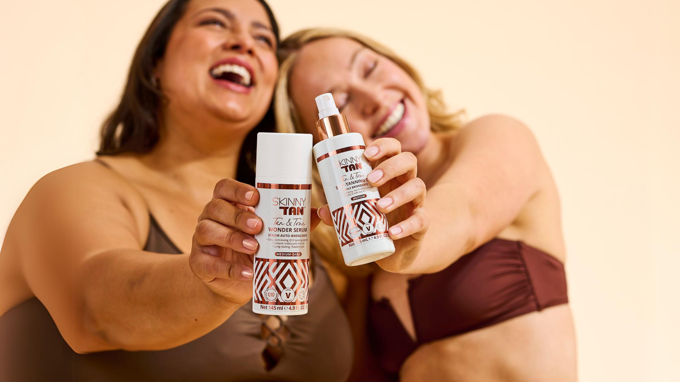 Models holding Wonder Serum and Tan & Tone Oil